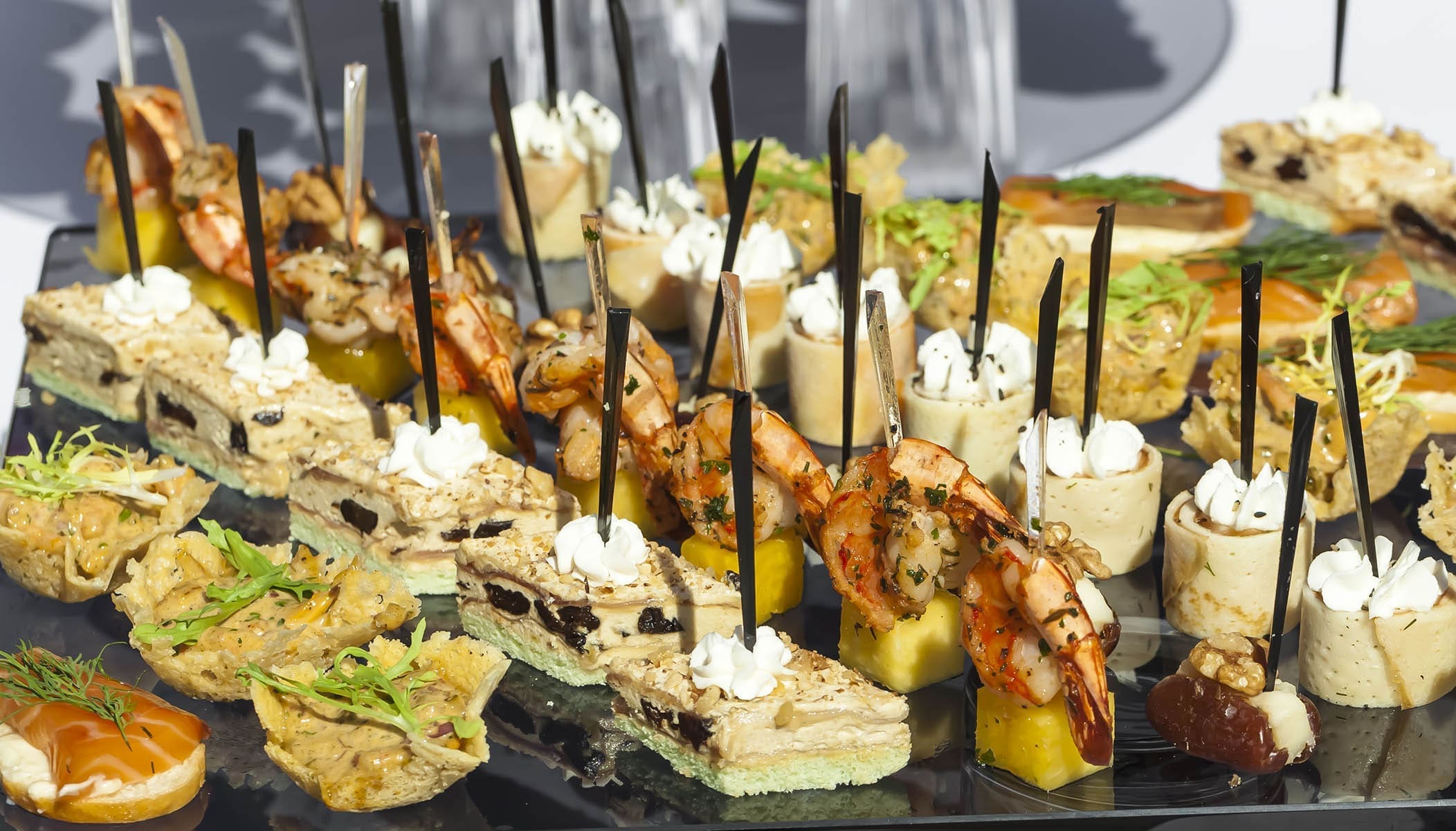 food meat, fish, vegetable canapes on a festive wedding table outdoor